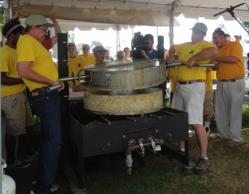 The Big Reveal - Handy employee's Chris and Jim remove the pan off the 300lb. cake. Photo by Brenda Bowen
